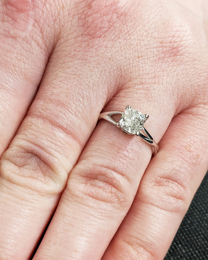 Cushion cut split shank engagement ring shown in real-life wear