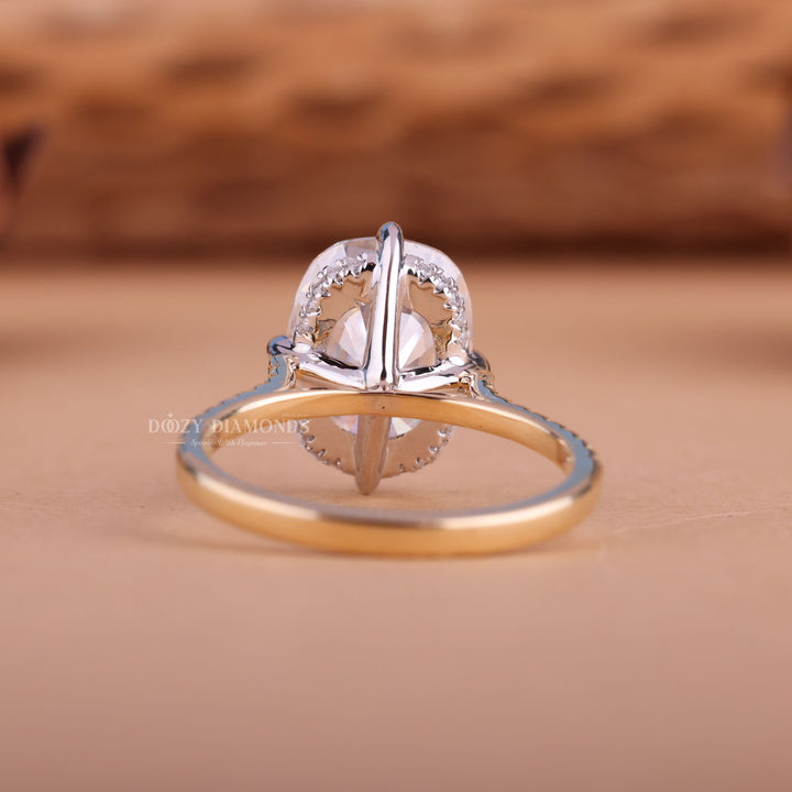 Cushion hidden halo engagement ring shown on hand for true-to-life sizing