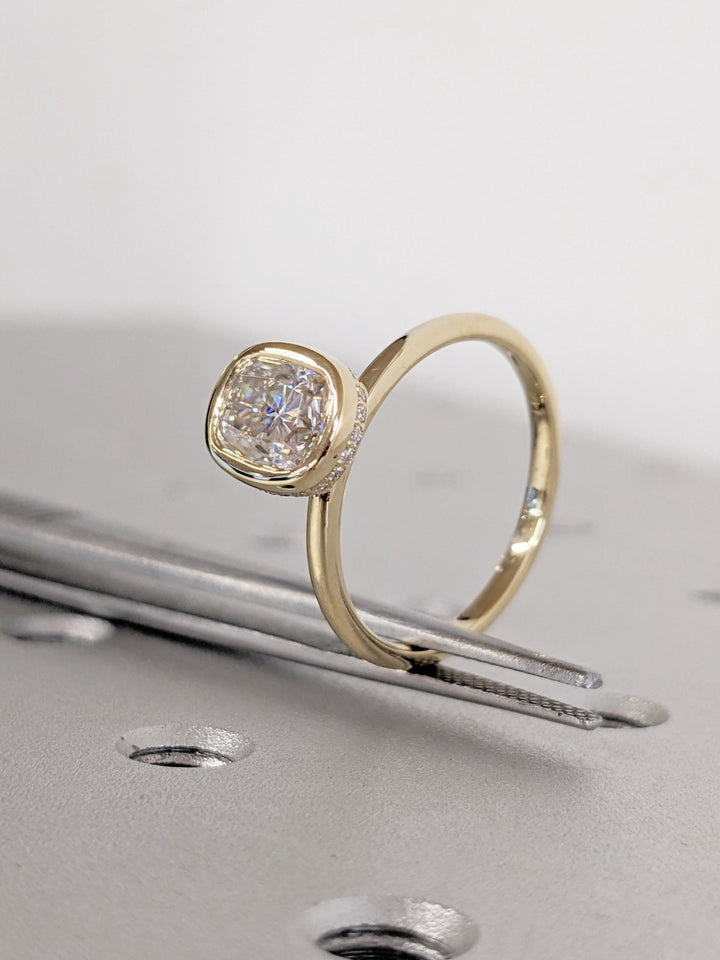 Detailed close-up of cushion hidden halo diamond engagement ring