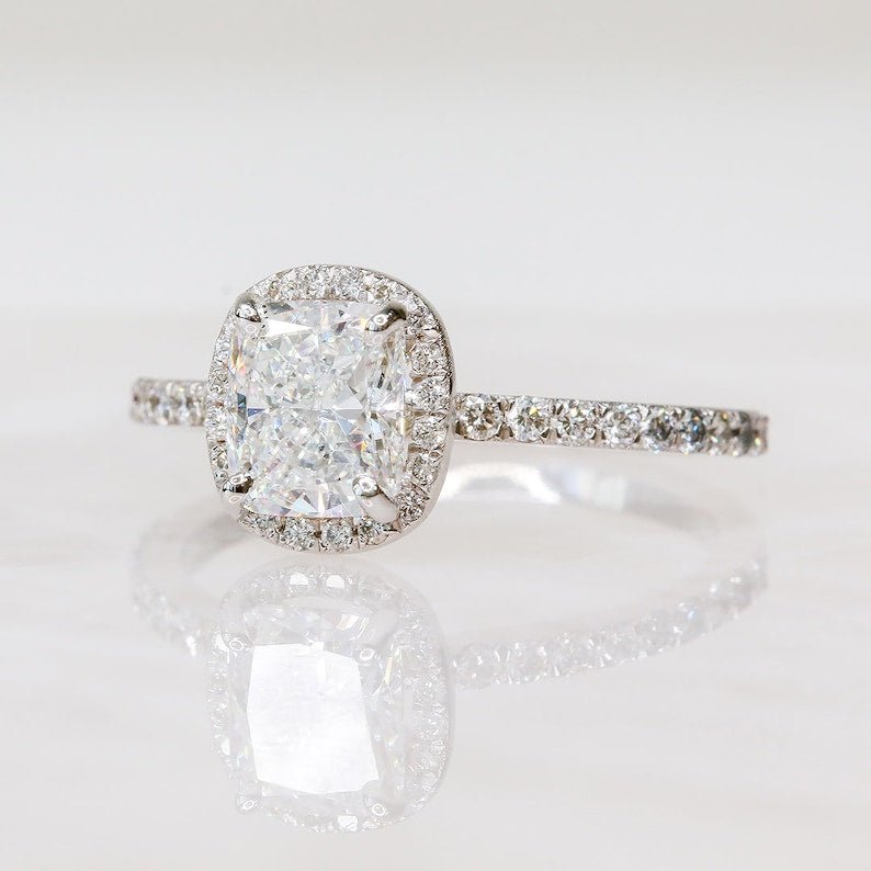 Close-up of cushion cut center diamond in halo engagement ring