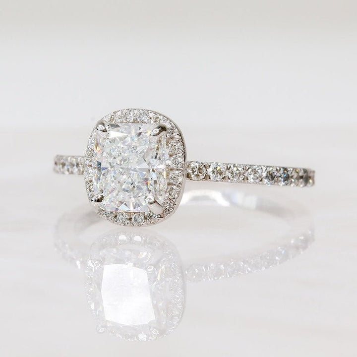 Close-up of cushion cut center diamond in halo engagement ring