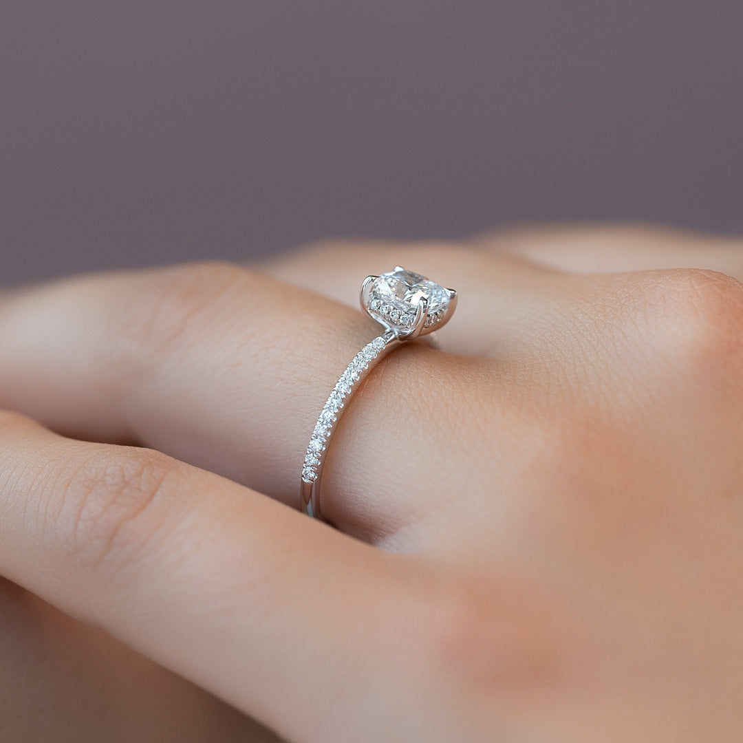Cushion hidden halo engagement ring offered in gold and platinum
