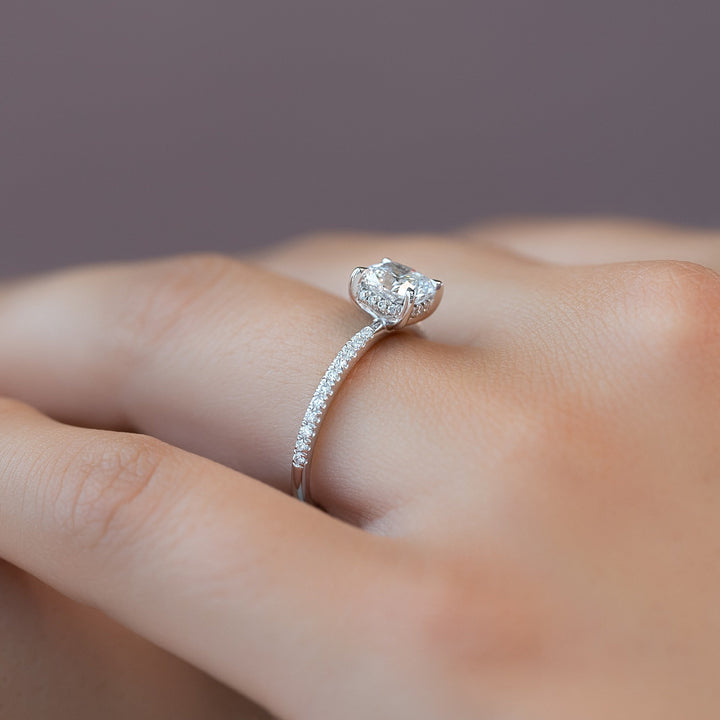 Cushion hidden halo engagement ring offered in gold and platinum