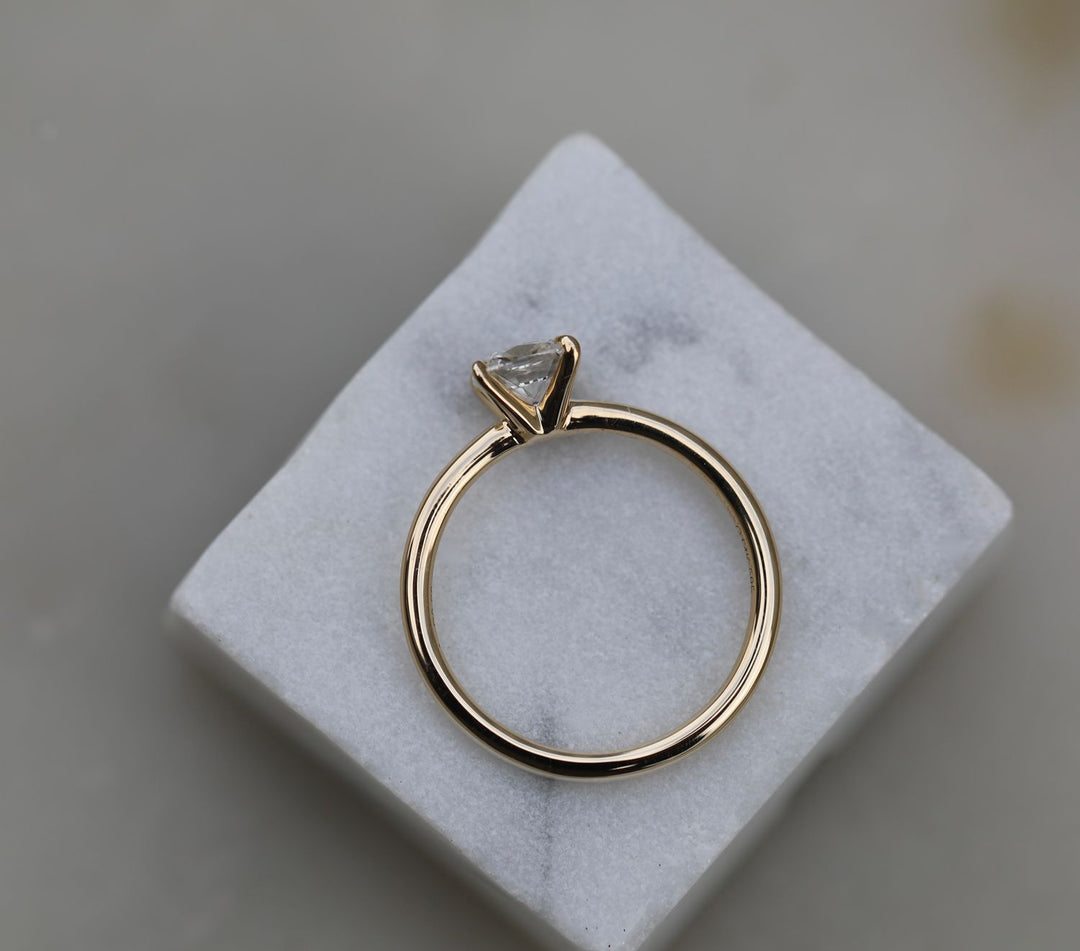 Cushion solitaire engagement ring offered in gold and platinum