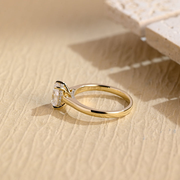 Cushion hidden halo engagement ring shown on hand for true-to-life sizing