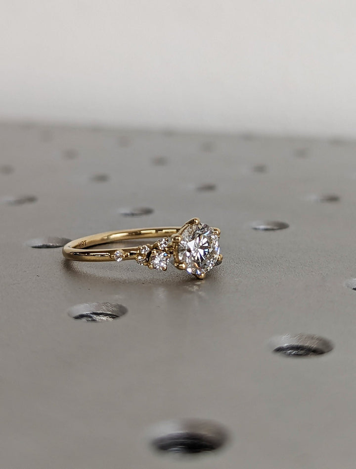 Round cluster engagement ring offered in gold and platinum