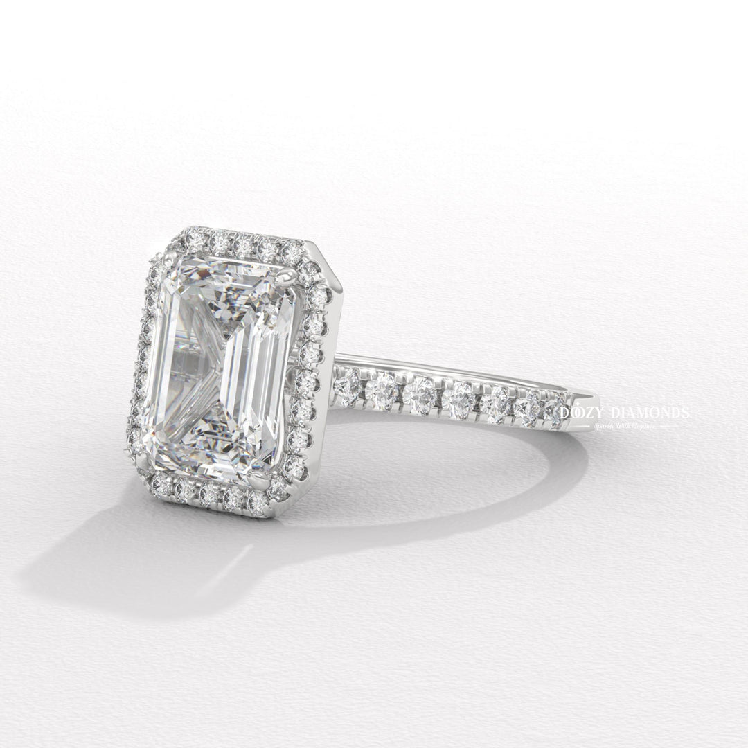 Emerald cut engagement ring shown with authenticity certificate