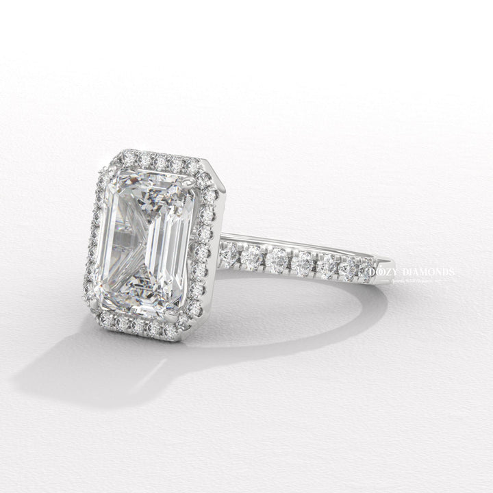 Emerald cut engagement ring shown with authenticity certificate