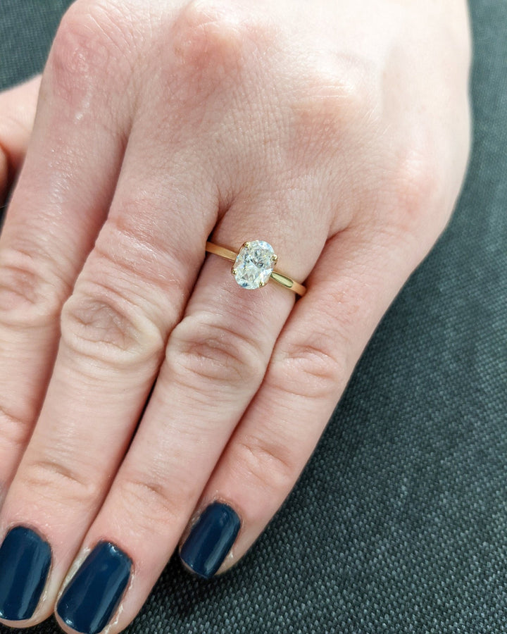 Oval solitaire engagement ring close-up highlighting diamond sparkle