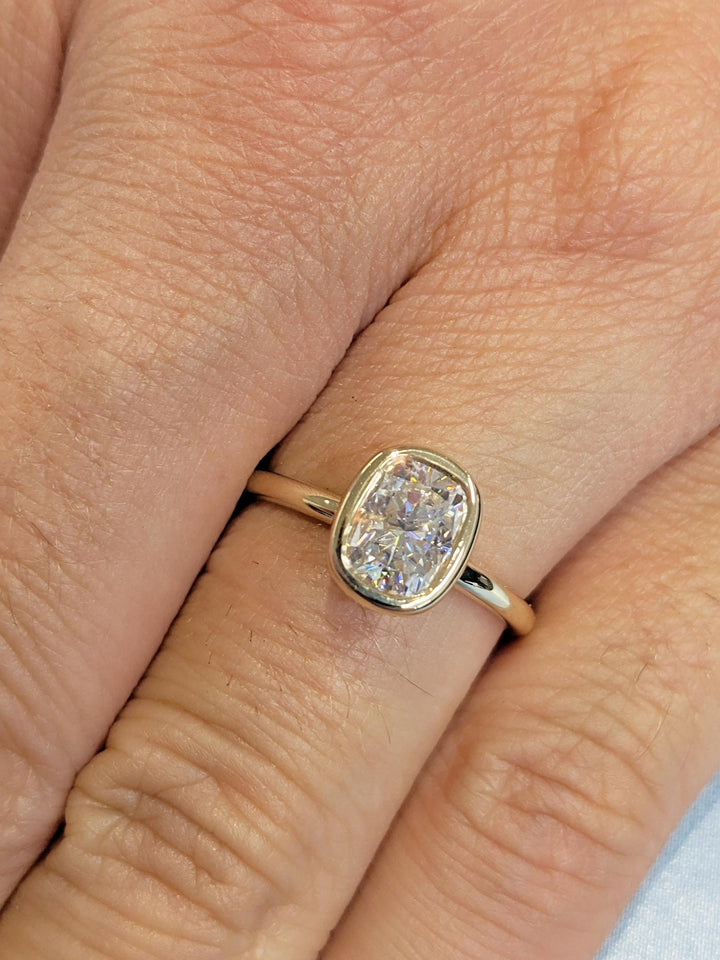 Side angle of cushion hidden halo diamond engagement ring