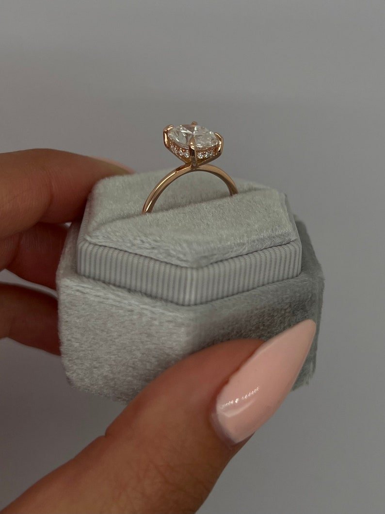 Fine craftsmanship detail on oval hidden halo engagement ring