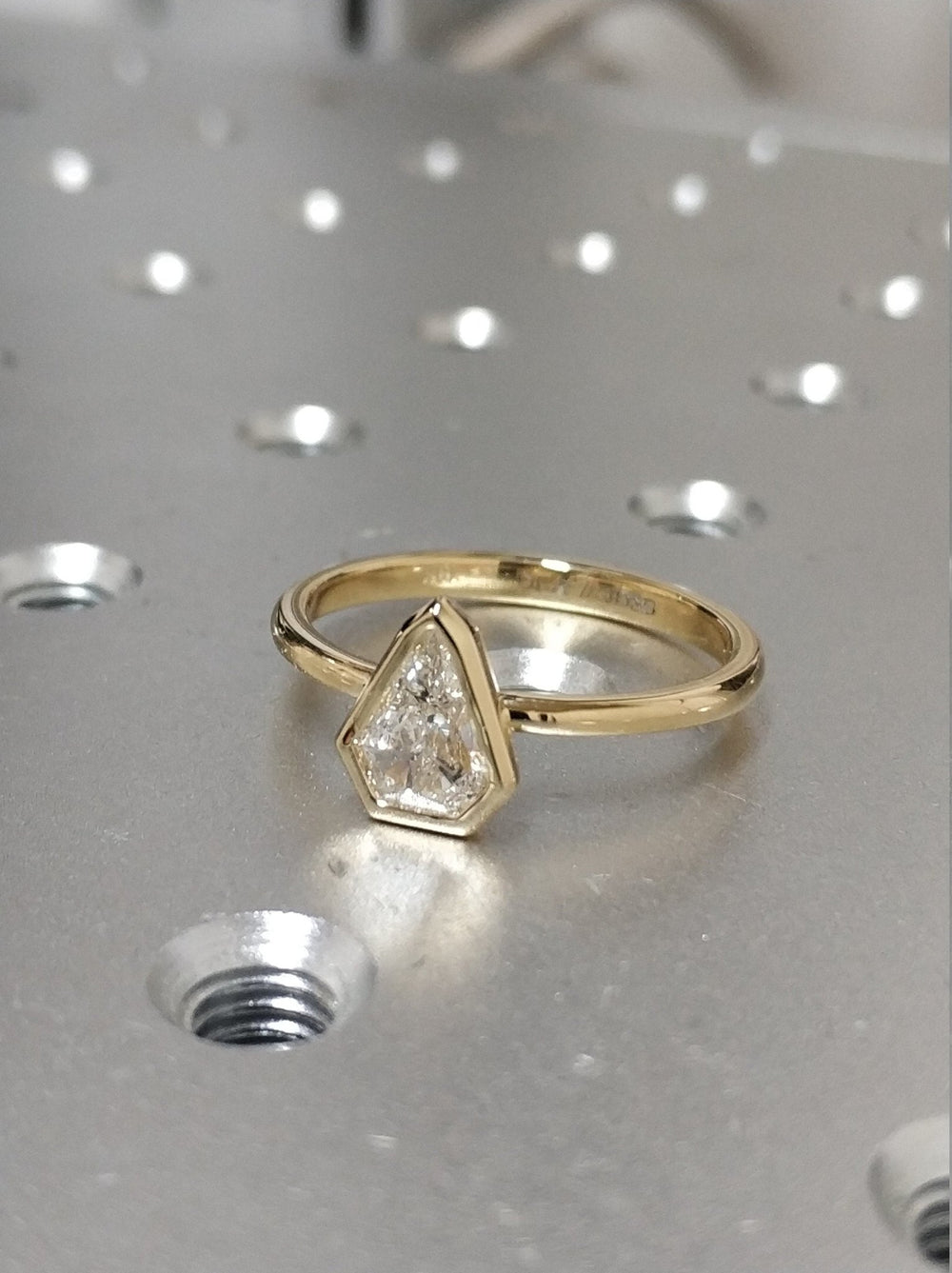 Kite bezel diamond ring presented in signature gift packaging