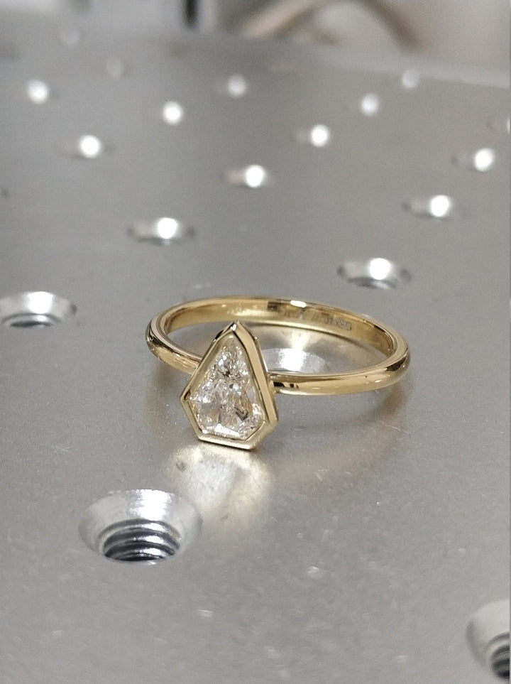 Kite bezel diamond ring presented in signature gift packaging