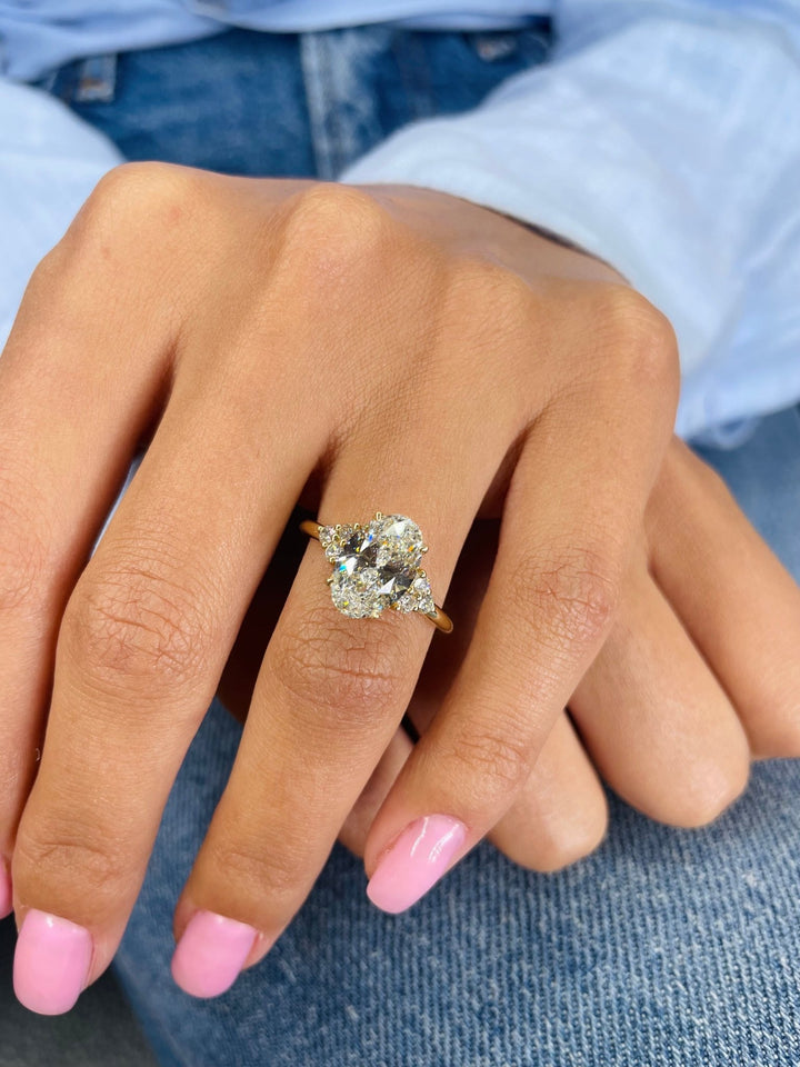 Side angle of oval cluster diamond engagement ring