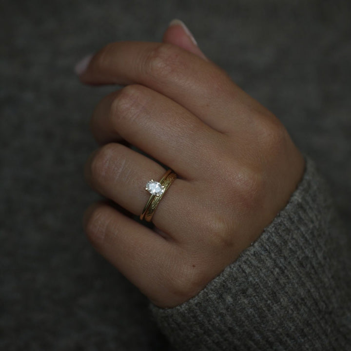 Oval solitaire lab grown diamond ring side profile in gold setting