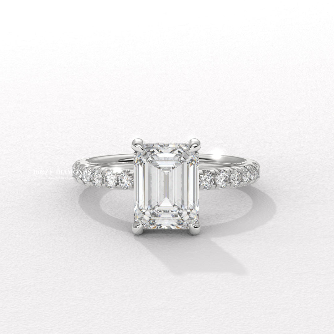 Emerald cut engagement ring shown with authenticity certificate