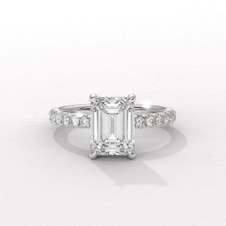 Emerald cut engagement ring shown with authenticity certificate