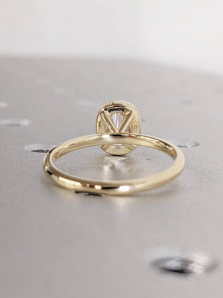 Cushion hidden halo engagement ring close-up highlighting diamond sparkle
