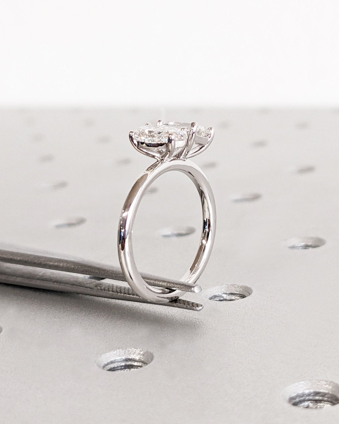 Close-up of pear cut center diamond in solitaire engagement ring