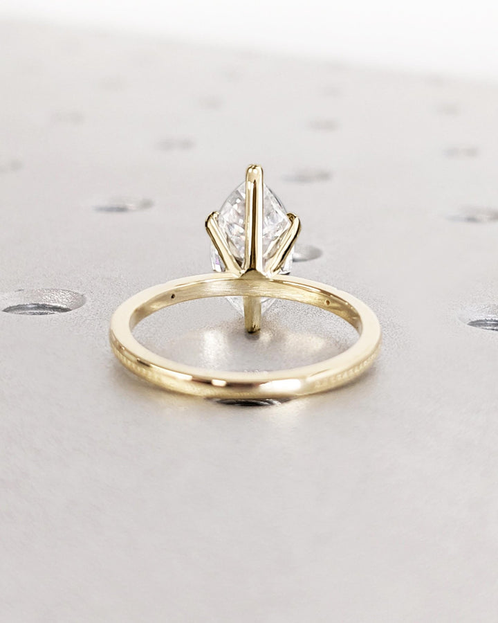 Lifestyle shot of marquise solitaire diamond ring on hand