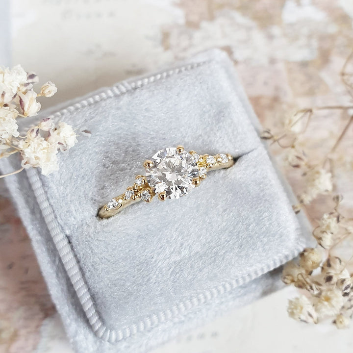 Round cut engagement ring shown with authenticity certificate