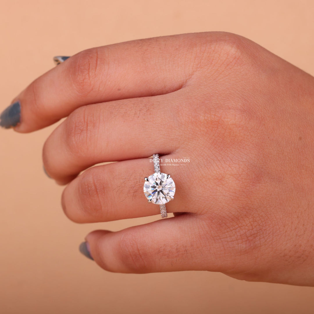 Lifestyle shot of round hidden halo diamond ring on hand