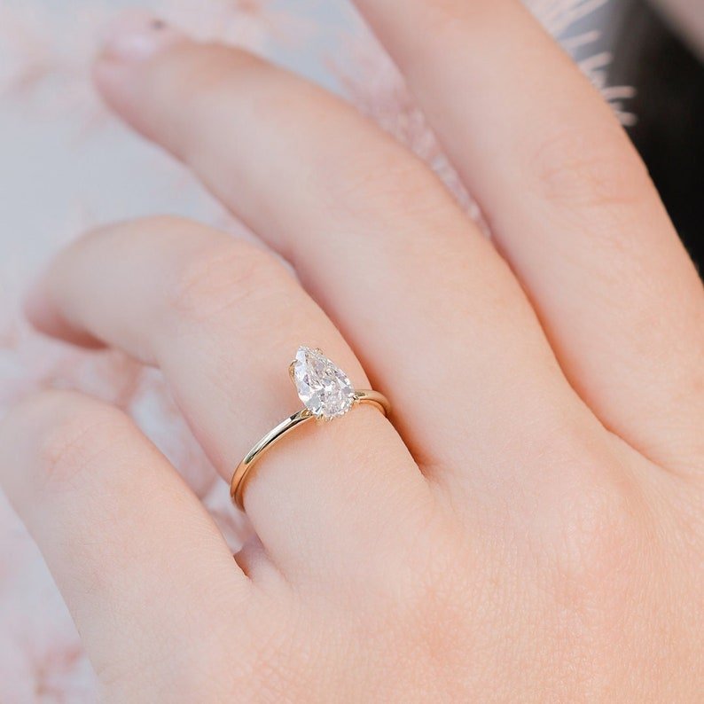 Shop the pear cut hidden halo engagement ring collection online