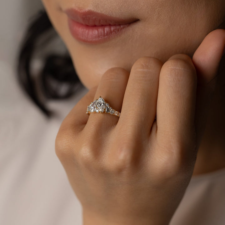 Unboxing view of pear cut cluster diamond engagement ring