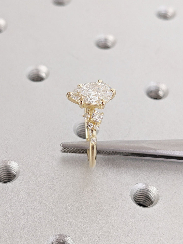 Pear cluster engagement ring finished in polished solid gold