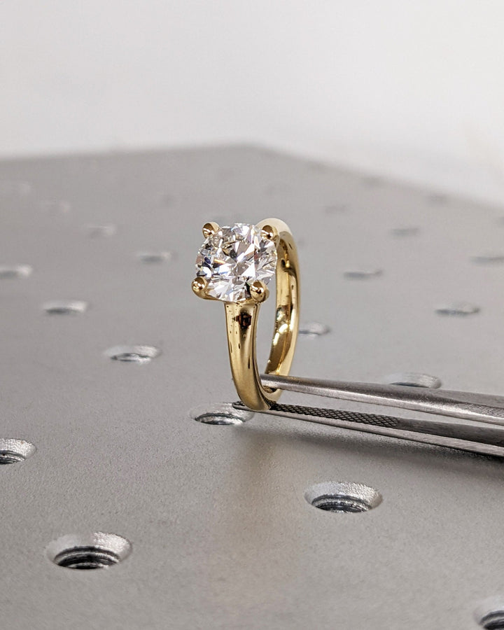 Round cut engagement ring side view showing band detail