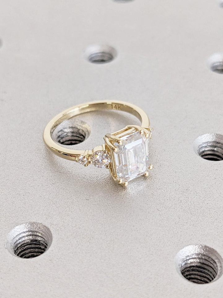 Unboxing view of emerald cut cluster diamond engagement ring