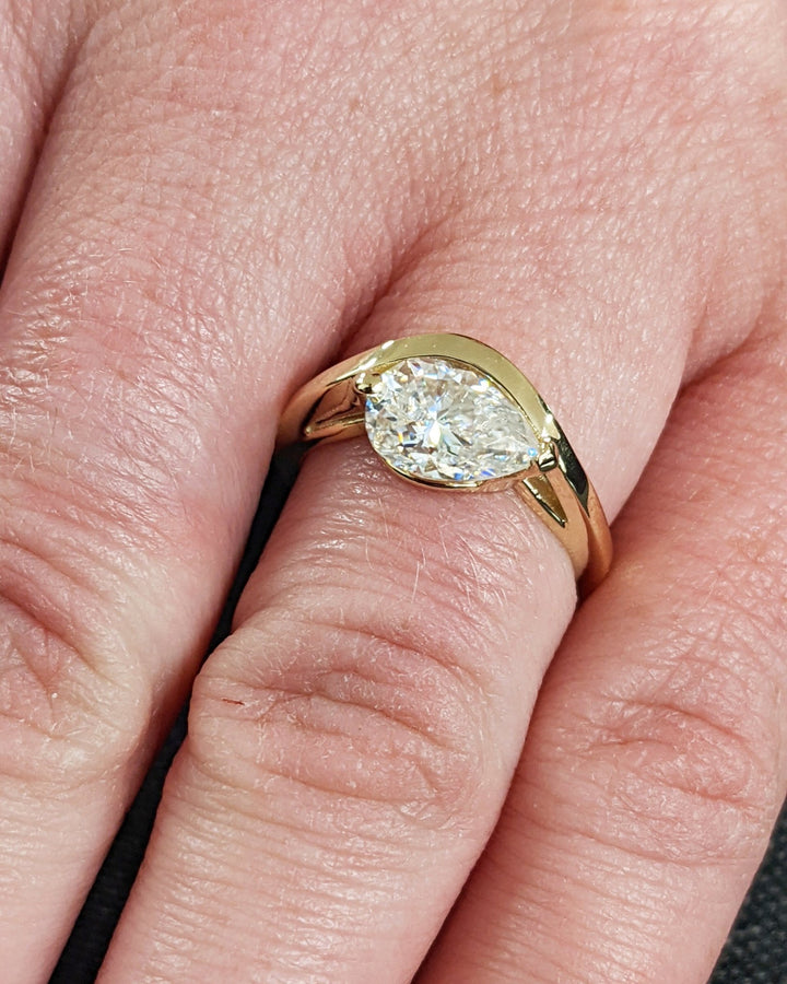 Pear solitaire engagement ring offered in gold and platinum