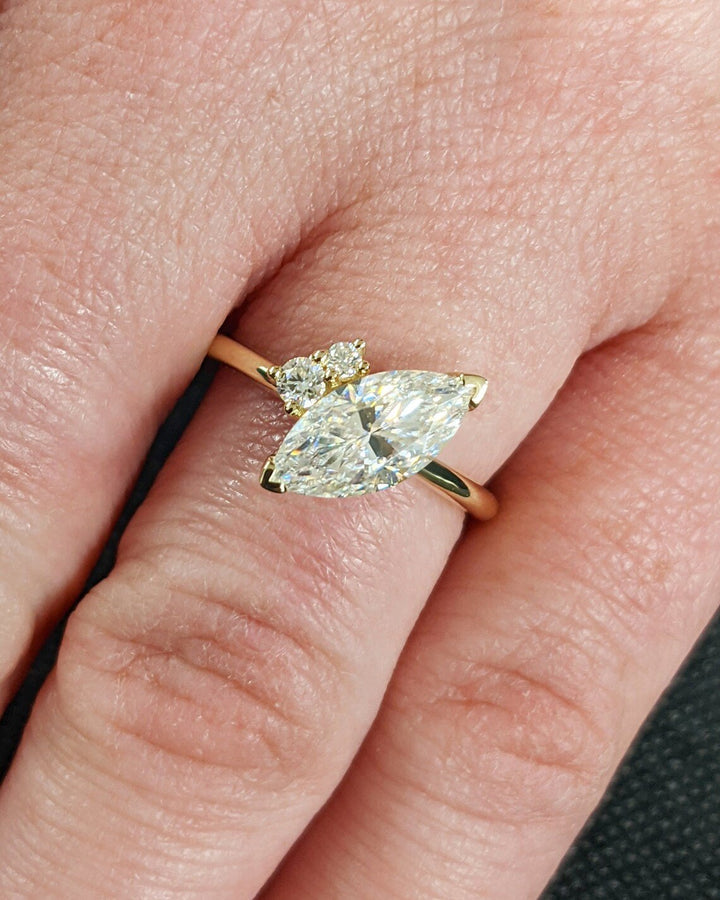 Lifestyle shot of marquise cluster diamond ring on hand