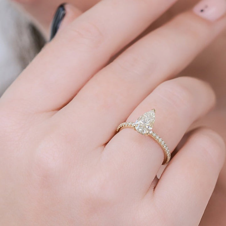 Pear hidden halo engagement ring viewed from the side