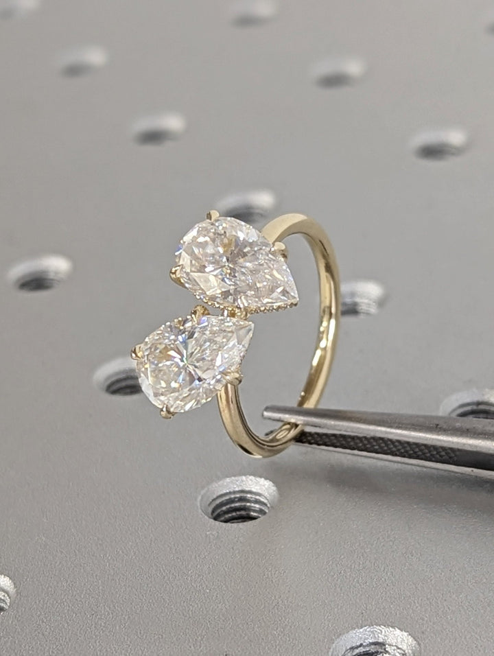 Close-up of pear cut center diamond in hidden halo engagement ring