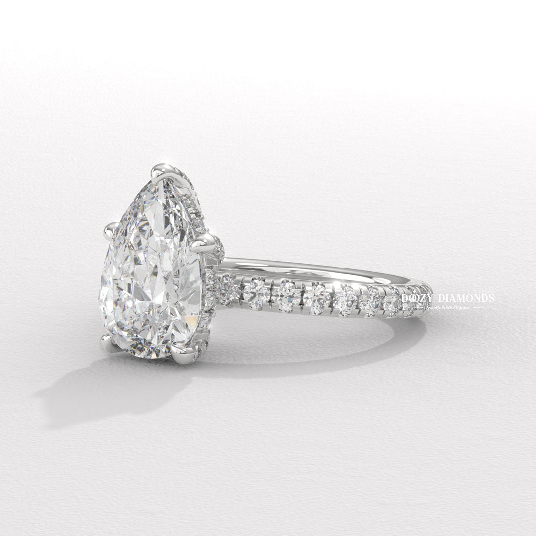 Pear hidden halo engagement ring close-up showing high clarity diamond clarity