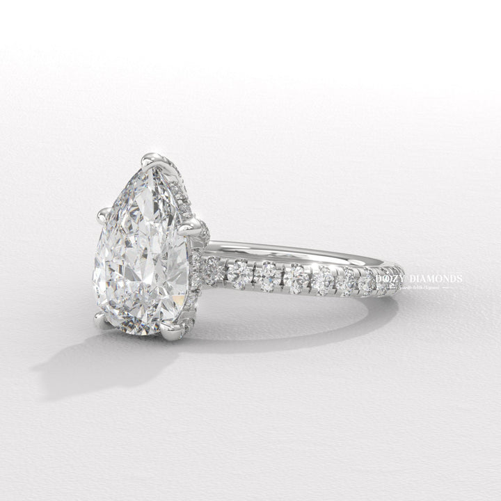 Pear hidden halo engagement ring close-up showing high clarity diamond clarity