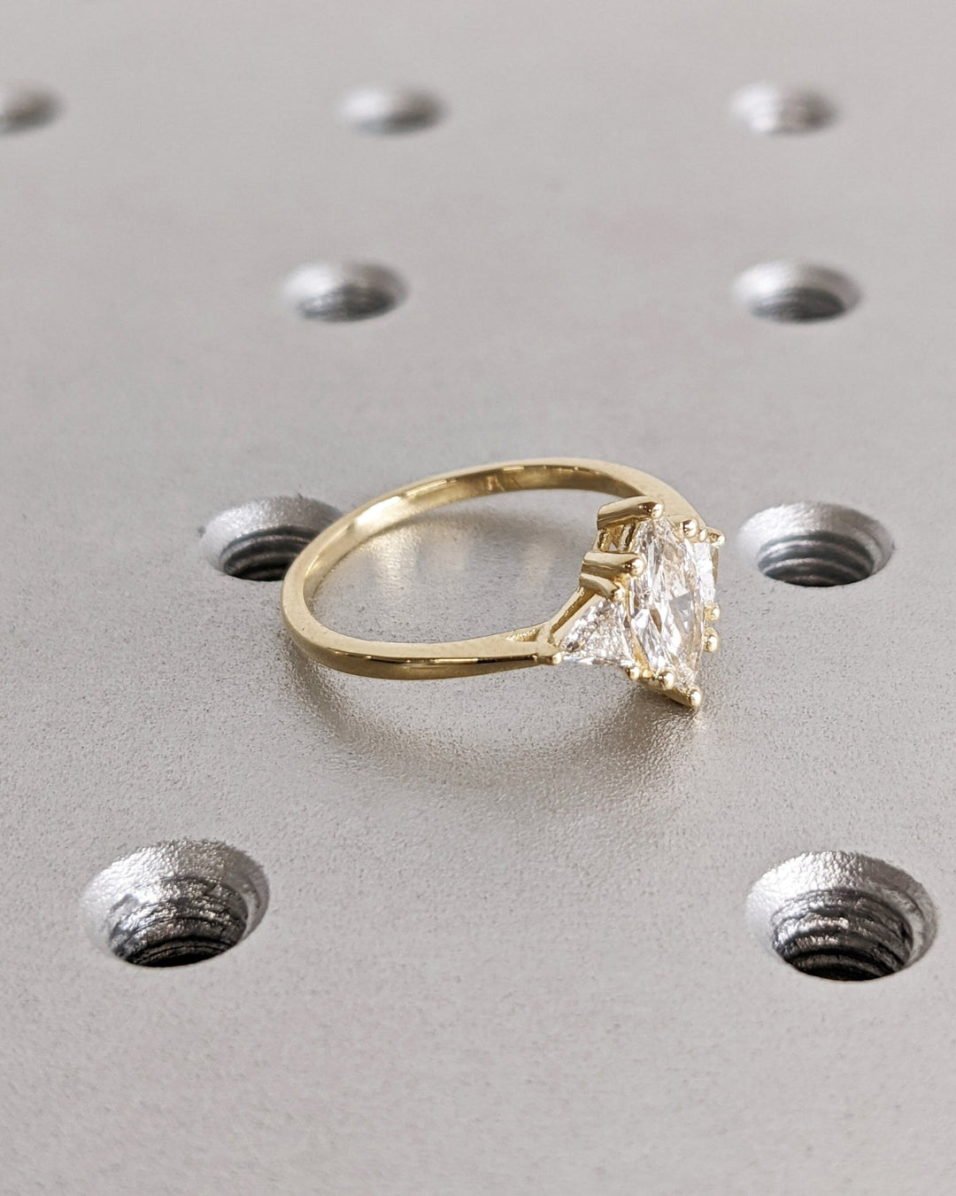 Detailed close-up of marquise solitaire diamond engagement ring
