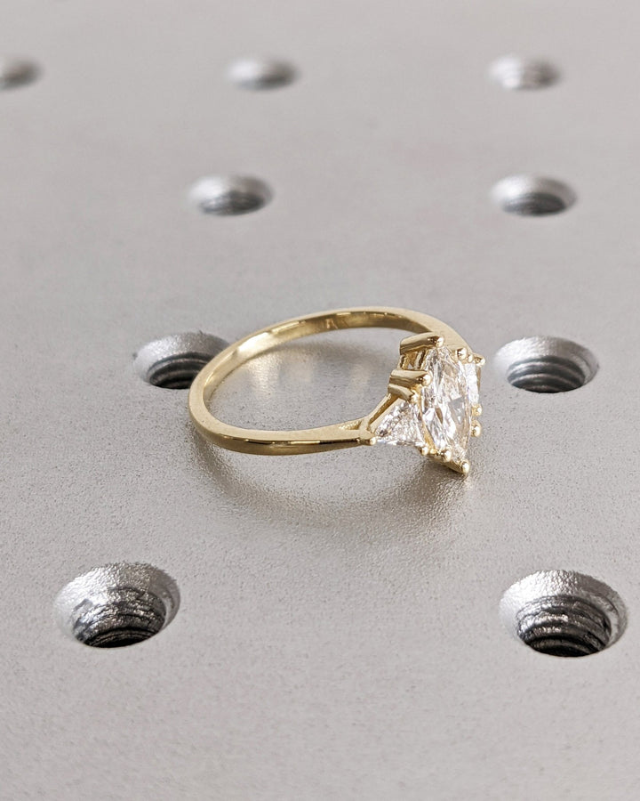 Detailed close-up of marquise solitaire diamond engagement ring