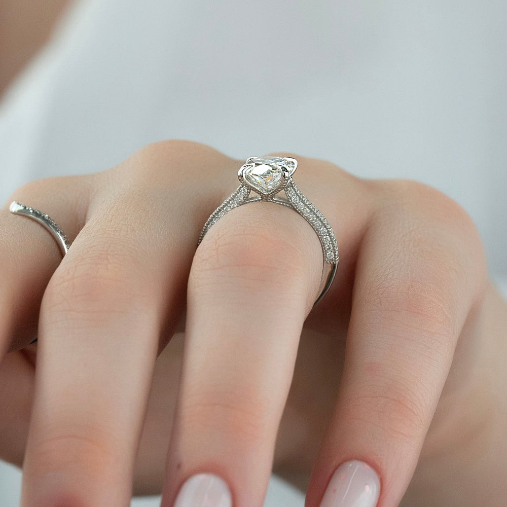 Certified emerald cut diamond featured in pave engagement ring