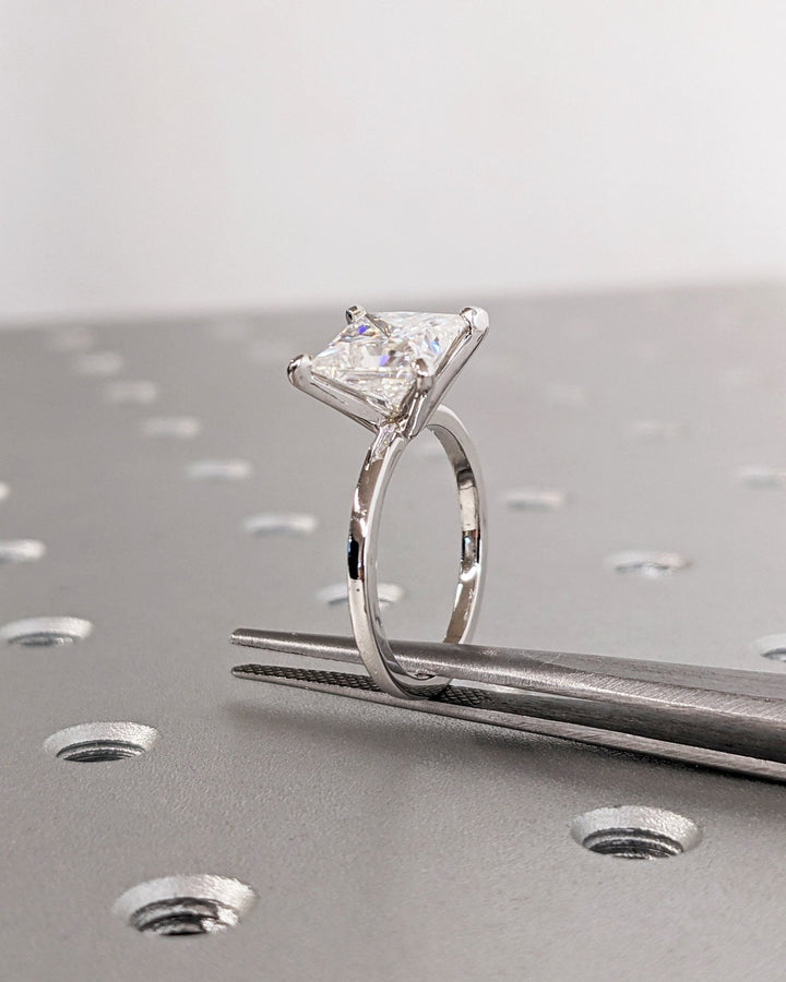 Side angle of princess solitaire diamond engagement ring