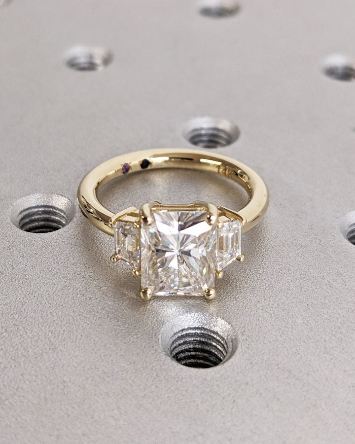 Radiant cut three stone engagement ring with IGI certified center diamond