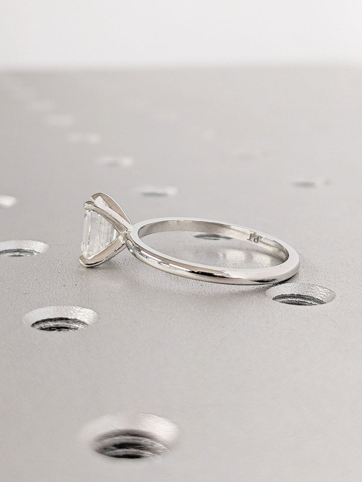 Detailed close-up of emerald solitaire diamond engagement ring