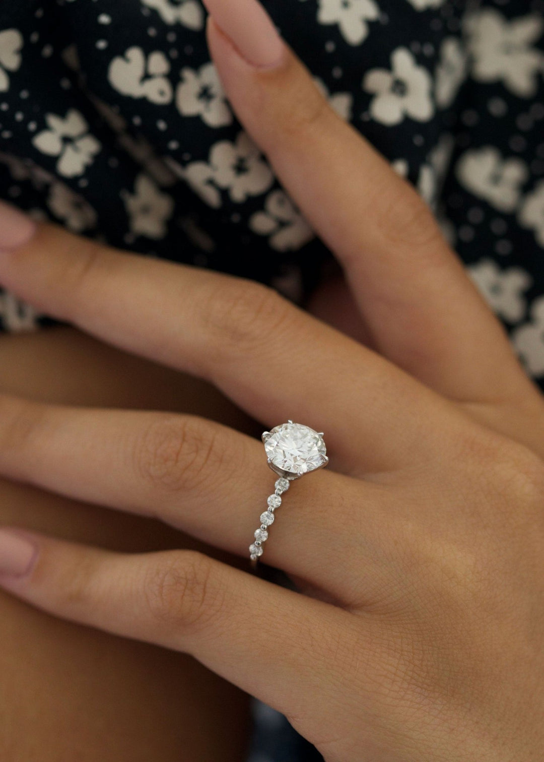 Round cut engagement ring shown with authenticity certificate