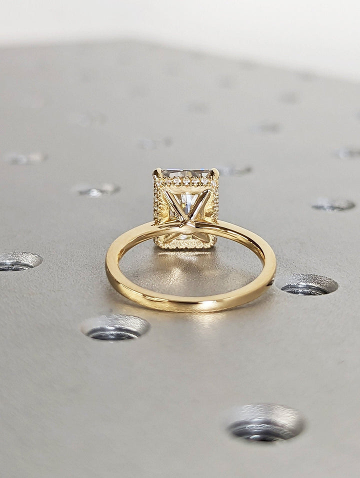 Radiant cut engagement ring shown with authenticity certificate
