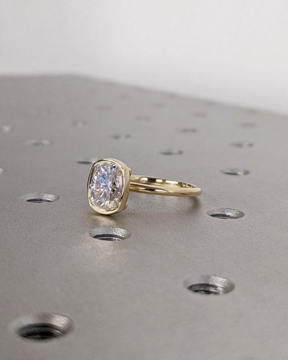 Detailed close-up of cushion bezel diamond engagement ring