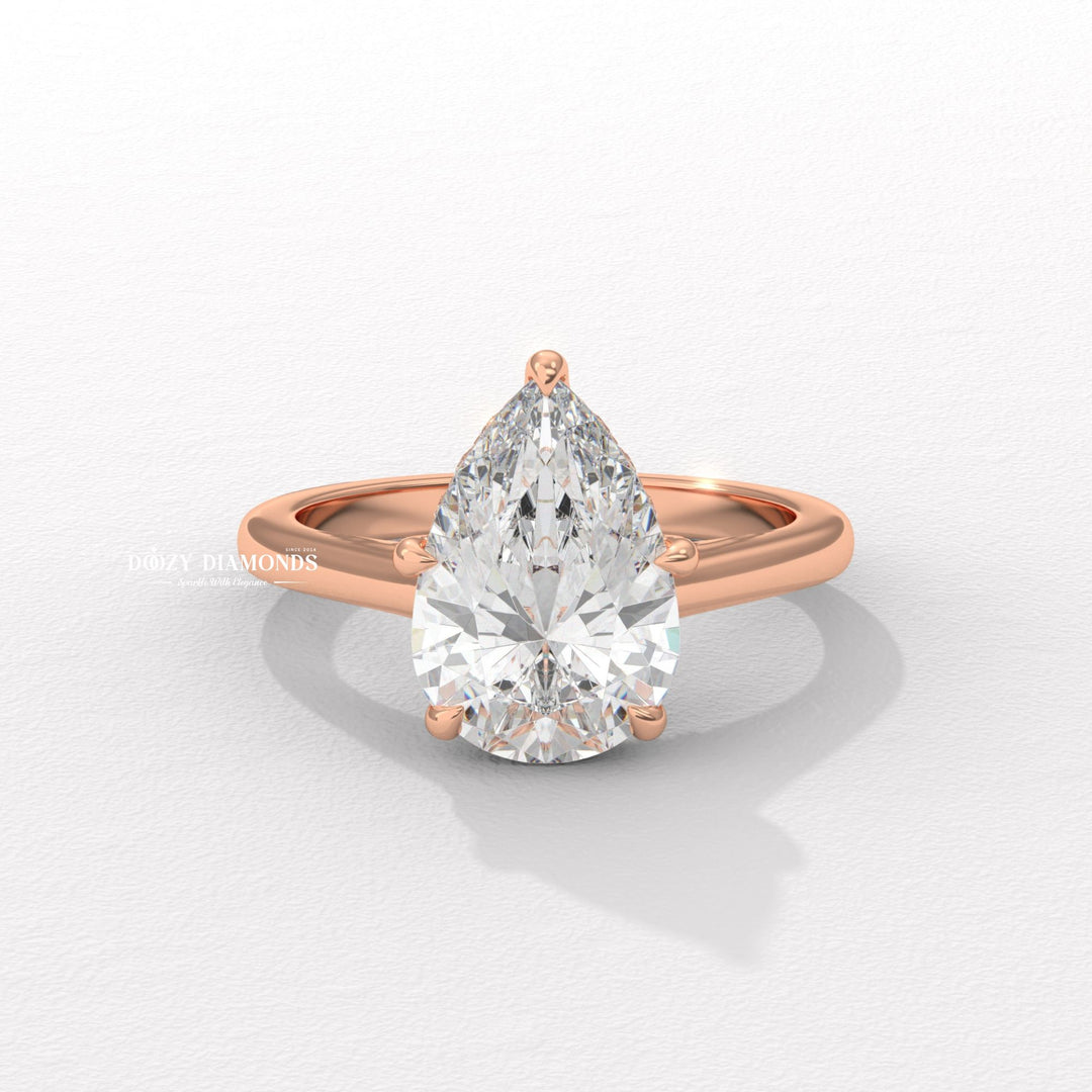 Pear solitaire engagement ring photographed in natural light