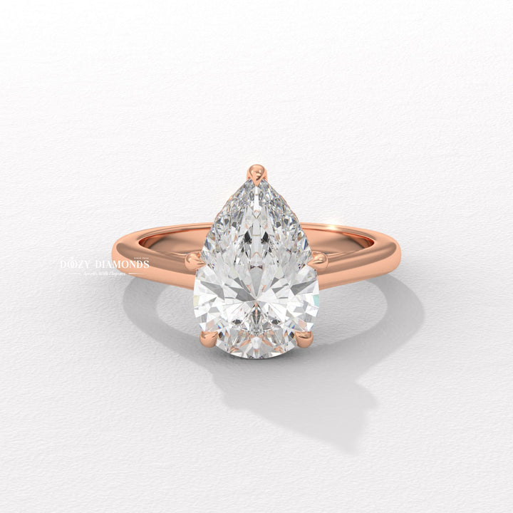 Pear solitaire engagement ring photographed in natural light