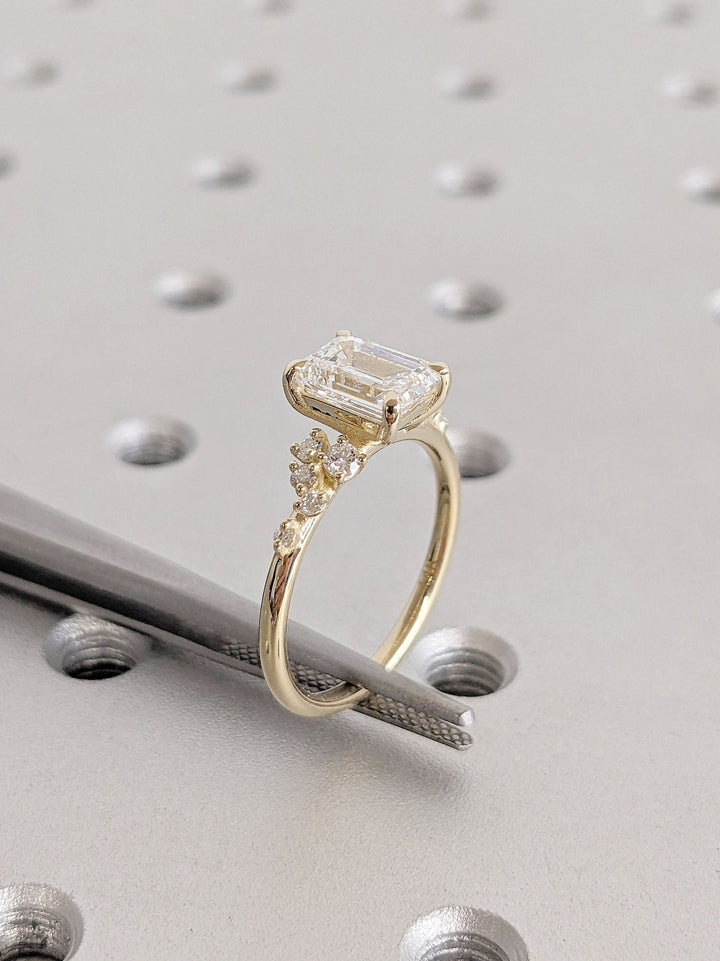 Emerald cluster engagement ring finished in polished solid gold