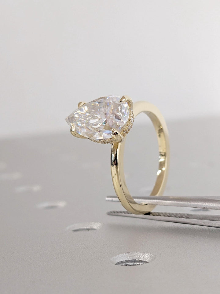 Shop the pear cut hidden halo engagement ring collection online